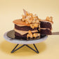 Serving a slice of Salted Caramel Chocolate Cake with Popcorns on Top (Mini Popstar Cake by Elevete Patisserie)