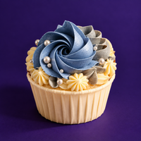 Denim Ruffle cupcake with a blue rosette, a soft grey swirl, cream stars and sugar pearls