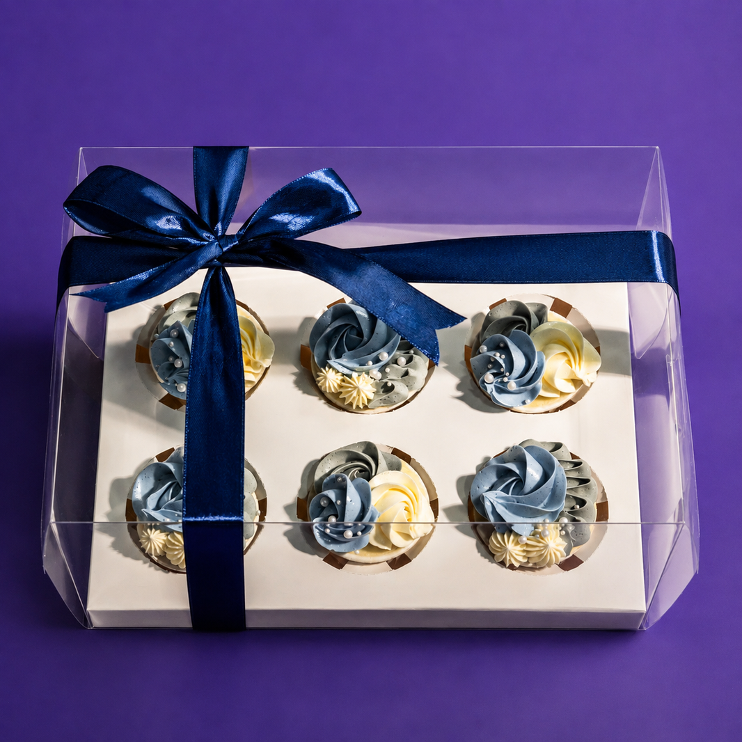 Denim Ruffle cupcake gift box: six blue, grey and cream cupcakes in a clear box tied with a navy ribbon