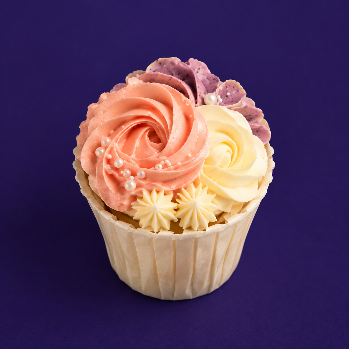 Single Blush Rosette cupcake with a peach rosette, a cream rosette and a ruffle of mauve petals