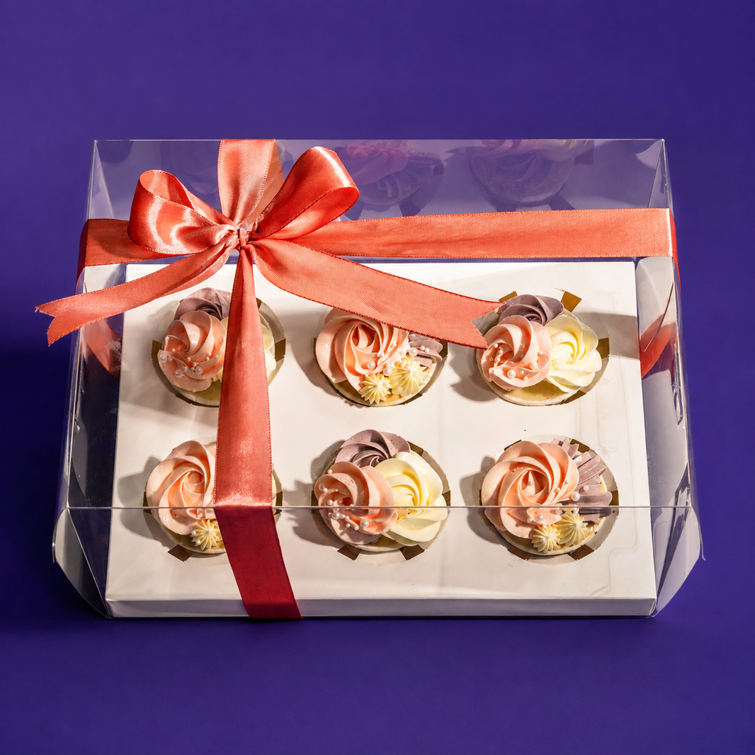 Blush Rosette cupcake gift box: six peach, cream and mauve cupcakes in a clear box tied with a coral ribbon