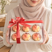 Holding the Blush Rosette box of six cupcakes, finished with a coral satin bow