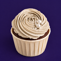 Side view of a Sunny Swirl ultimate chocolate cupcake, dark sponge under a pale sage swirl