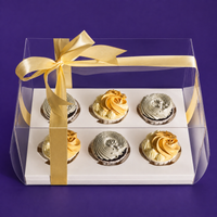 Sunny Swirl cupcake gift box: three gold and three pale sage cupcakes in a clear box tied with a gold ribbon