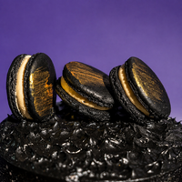 Close-up of edible gold and white splatter across the black buttercream of the Midnight Gold cake