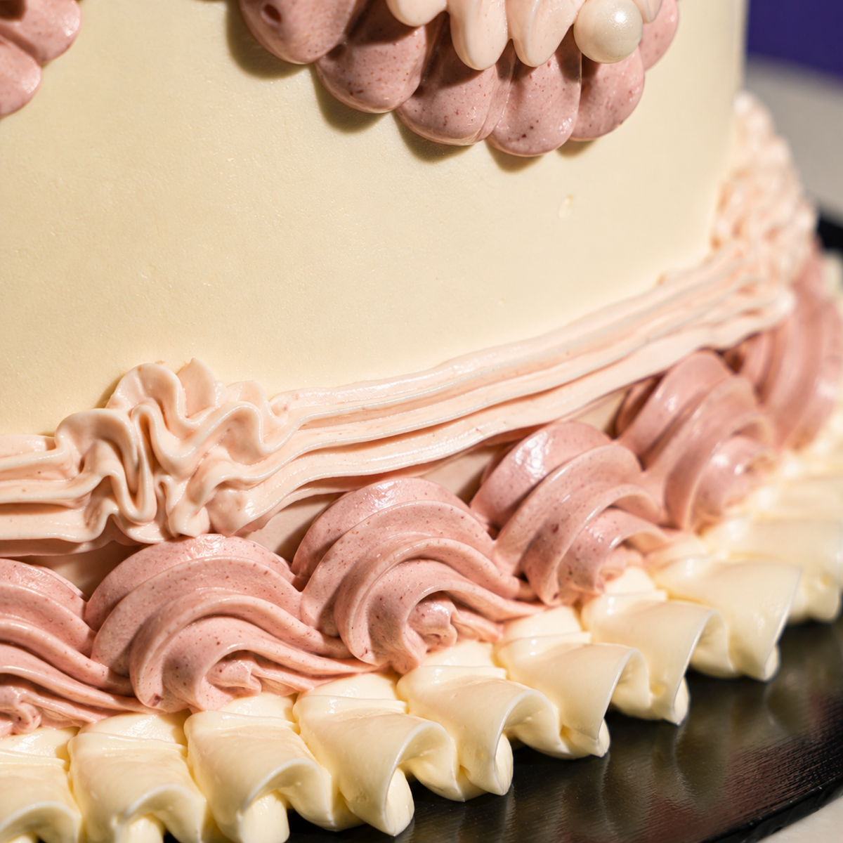 Layered rope and ruffle piping around the side of the Vintage Bloom designer cake in rose