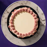 Top-down view of the Vintage Bloom cake in rose, showing the clear top for a message or candle