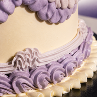 Rope and shell piping around the base of the Vintage Bloom designer cake in lilac