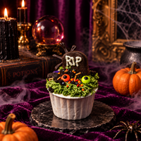 Graveyard cupcake with a chocolate cookie RIP headstone, green piped grass and candy eyeballs