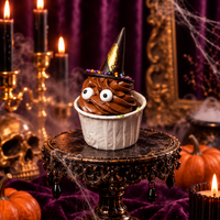 Chocolate swirl cupcake with googly eyes under a gold-trimmed witch's hat