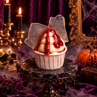 Vanilla swirl cupcake with raspberry drips and shards of sugar glass