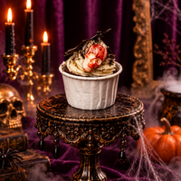 Cream swirl cupcake under cookie crumbs with a raspberry topping