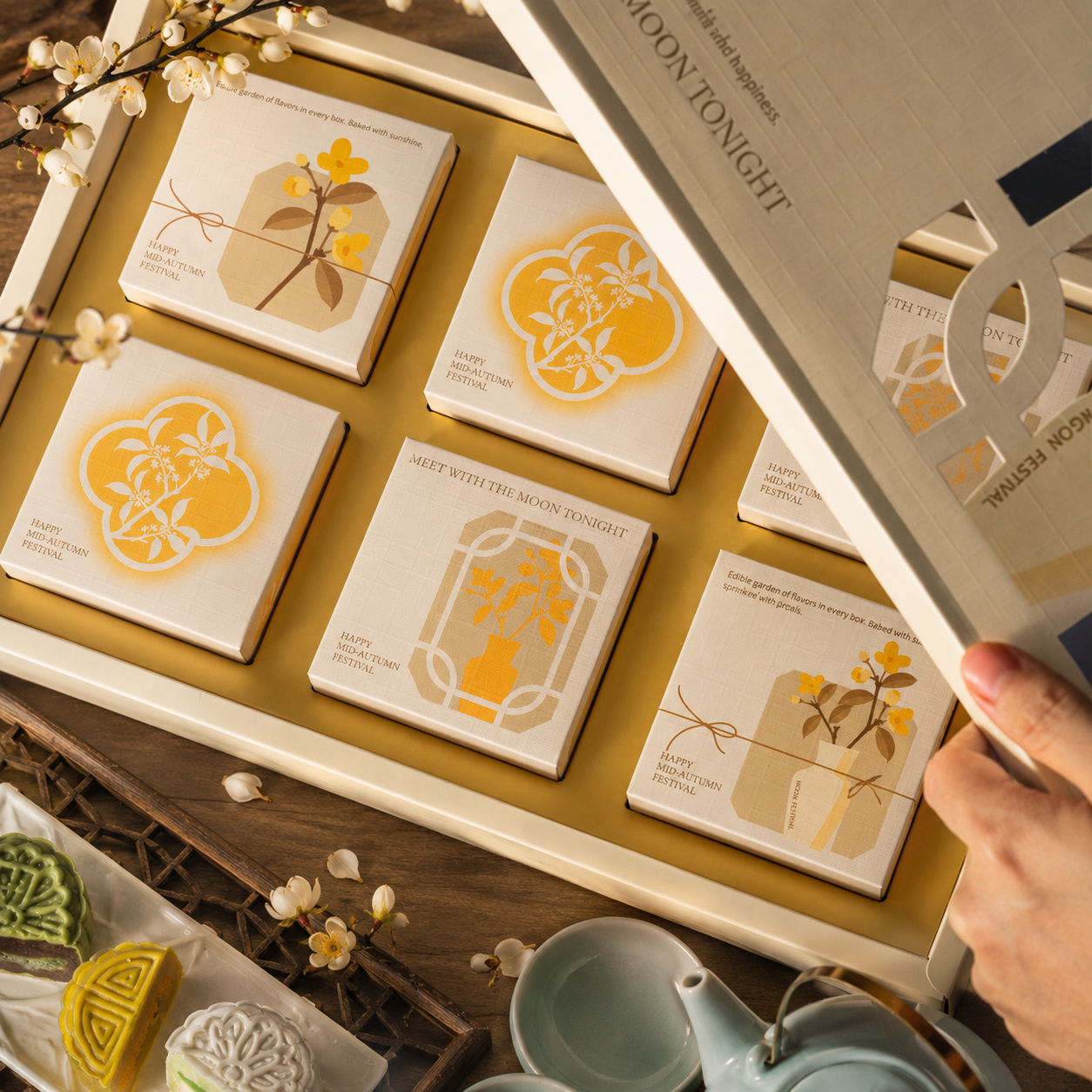 Open mooncake gift box showing six square snowskin mooncakes in two rows