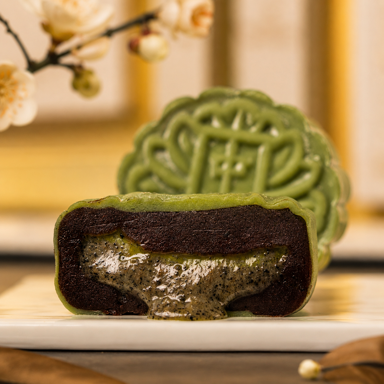 Salted egg yolk snowskin mooncake cut open with molten lava centre and pumpkin seed