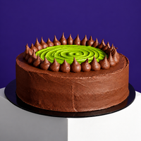 Dubai pistachio kunafa cake with chocolate ganache and a pistachio cream swirl on top