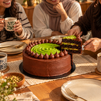 Friends sharing slices of Dubai pistachio kunafa cake with coffee at home