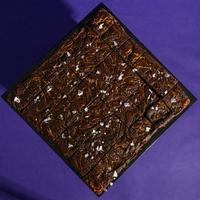 Sourdough salted caramel brownies pre-cut into 36 squares on a black board, ready to share