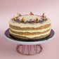 Top View of Lemon Poppyseed cake decorated with poppyseed, dehydrated lemon & rose petals on top by Elevete Patisserie