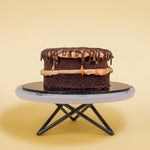Side View of Mini Salted Caramel Chocolate Cake with Chocolate & Salted Caramel Drizzle On Top by Elevete Patisserie