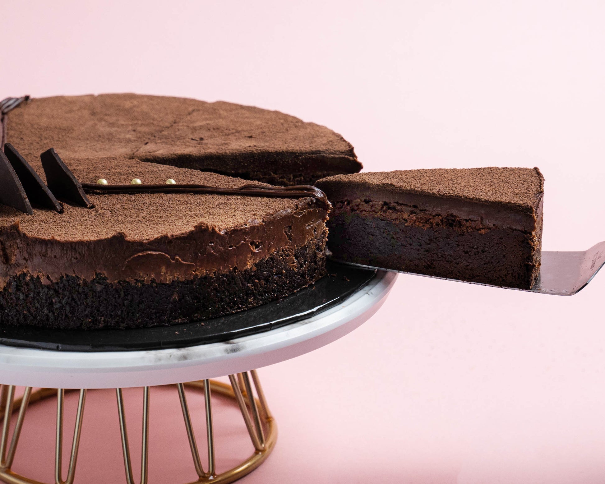 Serving a slice of Nutella Fudge Cake by Elevete Patisserie