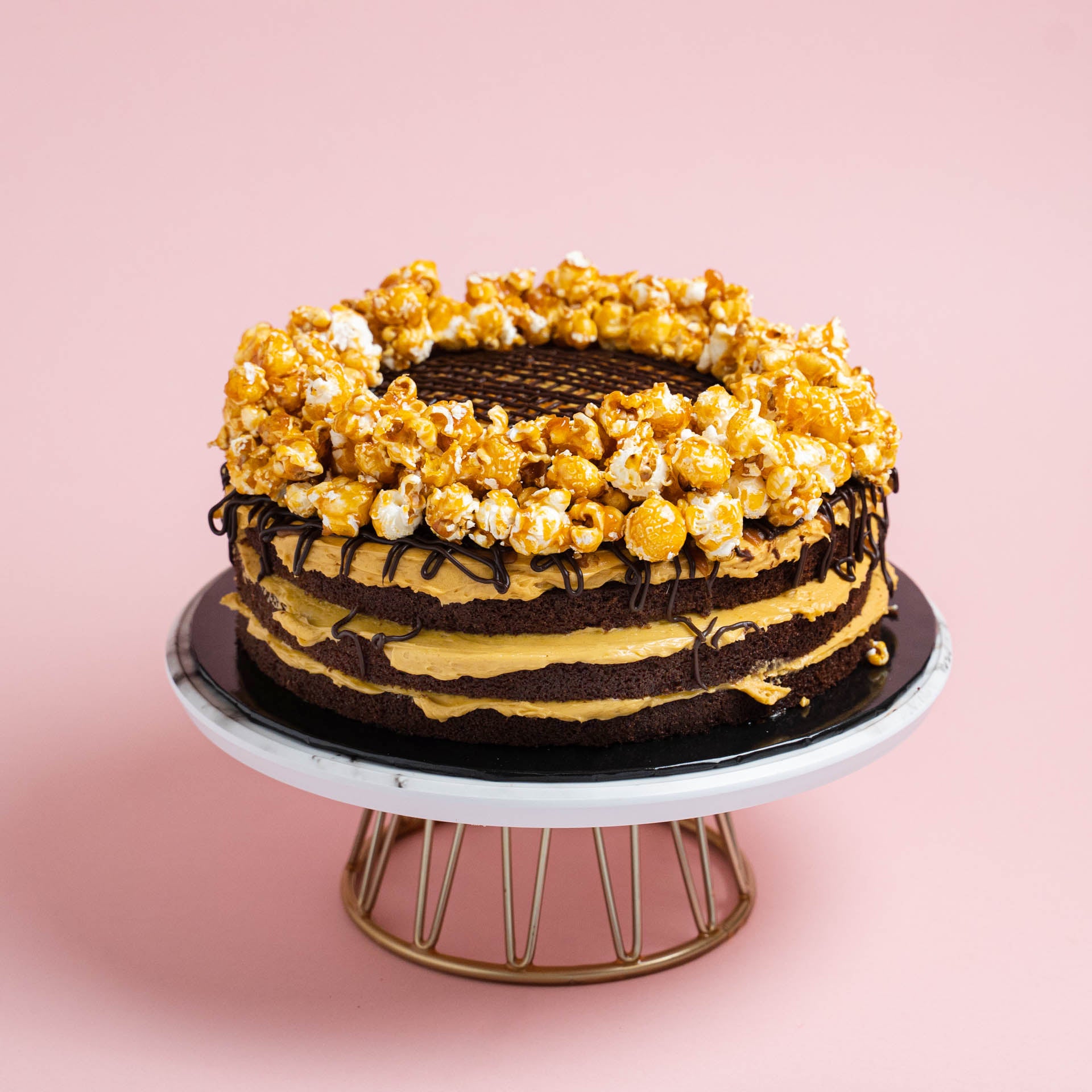 30 Degrees angle View of Salted Caramel Chocolate 9 Inch Cake with Popcorns on Top by Elevete Patisserie